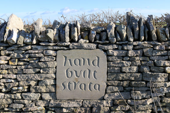 Hand Built Strata carved sign set into wall at Chapman's Pool descent