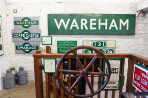 Wareham station sign on wall of Swanage Railway museum