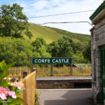 Corfe Castle railway station sign and flowers