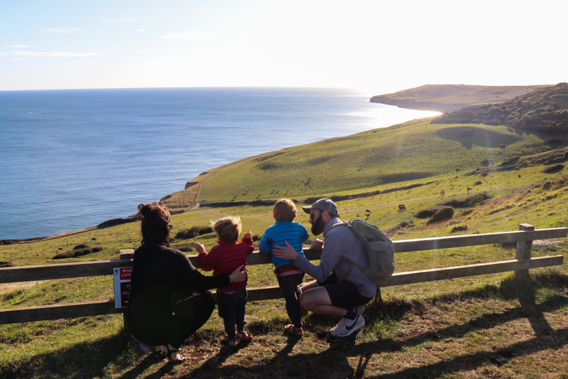 Family looking out at view at Dancing Ledge