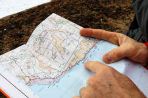 Person pointing to Bat Hole near Durdle Door on map