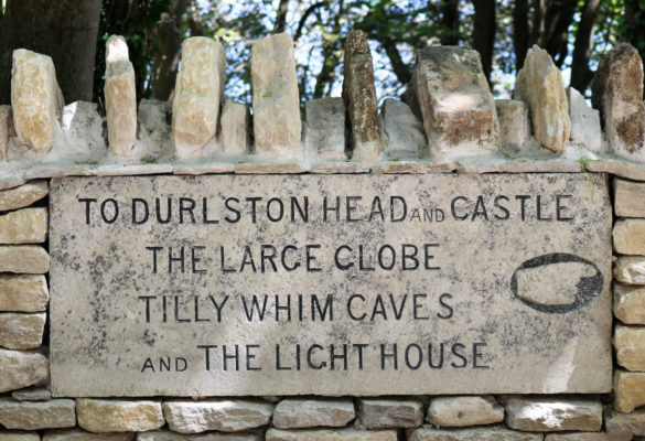 Durlston head and castle sign carved into stone wall