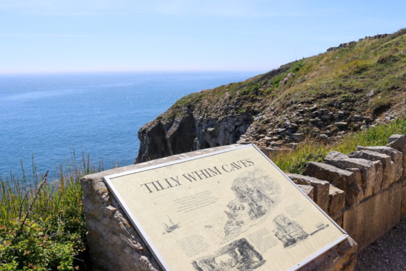 Tilly Whim caves information poster at Durlston Country Park