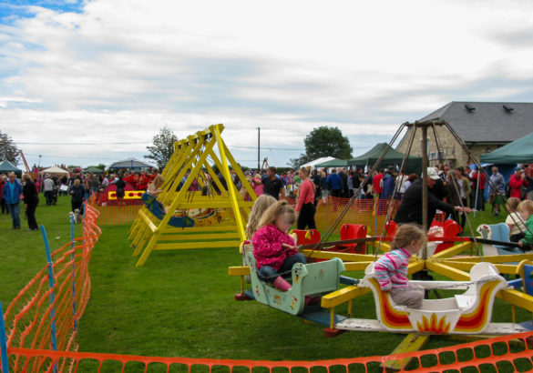 Traditional swing boats and roundabout at Harman's cross village field day