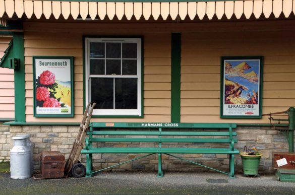 Bench and vintage style poster at Harman's Cross station