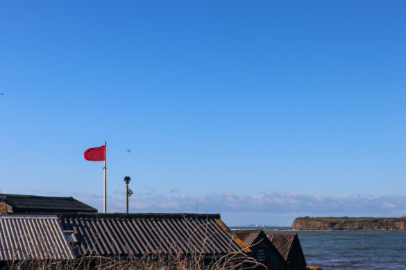 Red warning flag flying for Lulworth Ranges at the Kimmeridge Bay boat park area