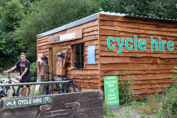 Man holding bike outside the Cycle Experience bike hire hut in Norden