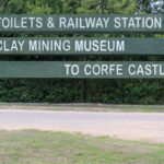 Sign at Norden Railway Station for the clay mining museum