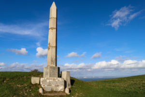 The Obelisk in Swanage with blue sky behind