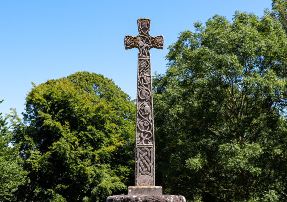 The Celtic Cross with trees behind in Studland village