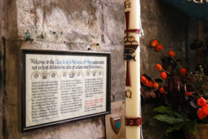 Candle and welcome sign in Studland's church