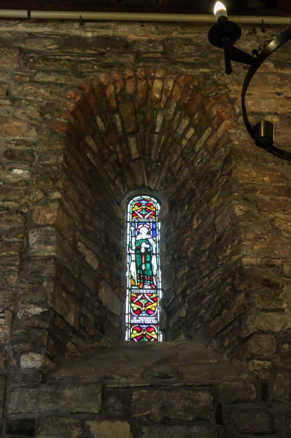 Stained glass window inset into wall in Studland's St Nicholas' Church