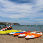 Kayaks and pedalo on Swanage beach
