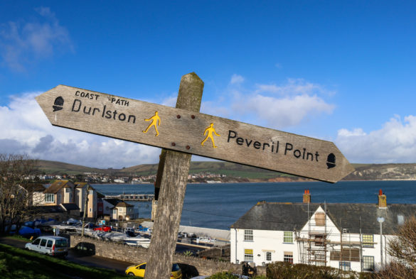 Wooden sign on the Downs showing the way to Durlston and Peveril Point