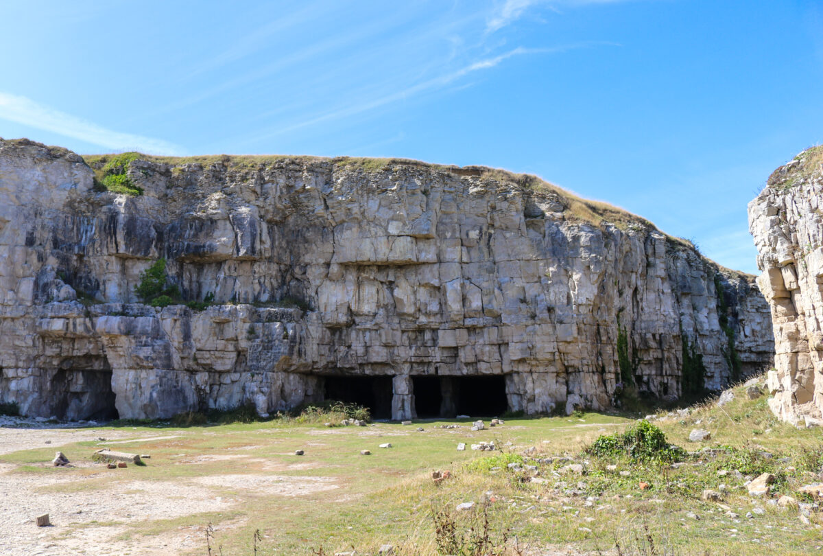 Winspit quarry caves with rocks scattered in front