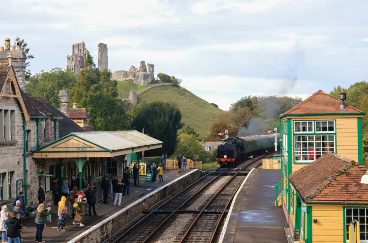People on the platform as train comes in at Corfe Castle station
