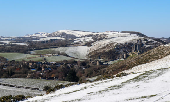 Corfe Castle and village viewed from Purbeck Hills in the snow