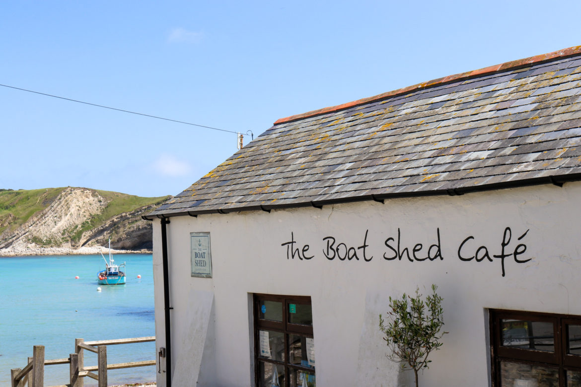 Boat in the sea by The Boat Shed Cafe in Lulworth