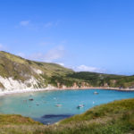 Lulworth Cove with boats and person