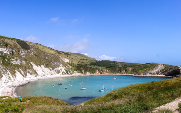 Lulworth Cove with boats and person