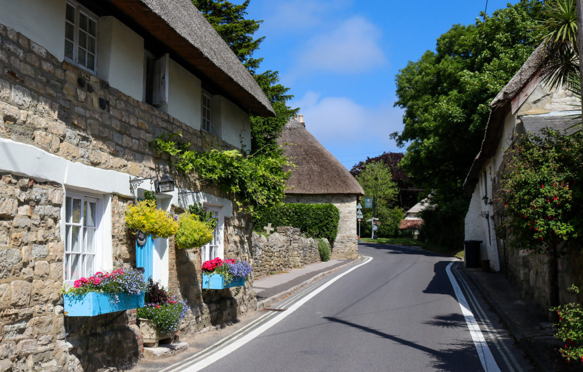 Thatched cottages with window boxes on street in West Lulworth