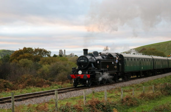 Steam train going past Corfe Castle