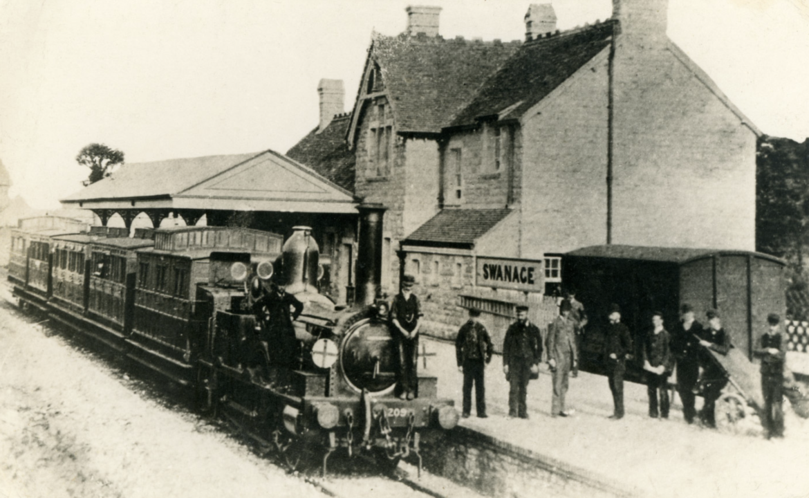 Archive image of men standing on Swanage Railway station platform