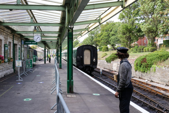 Man in overalls and hat on Swanage train platform