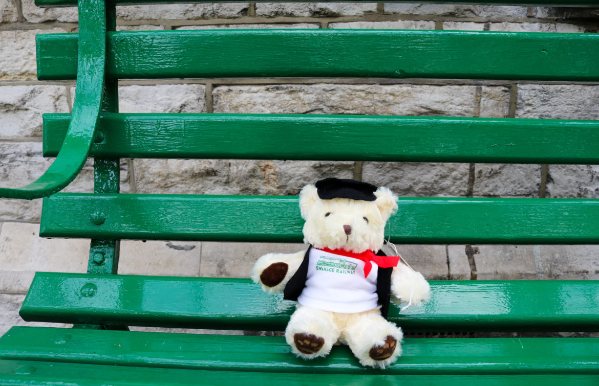Teddy bear sitting on a bench at Swanage station