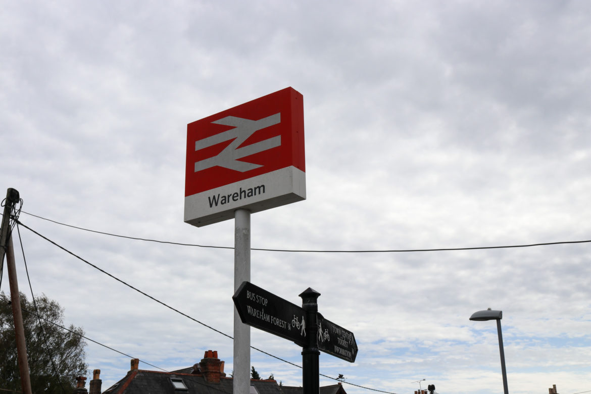 Sign for Wareham Station and bus stop walking route