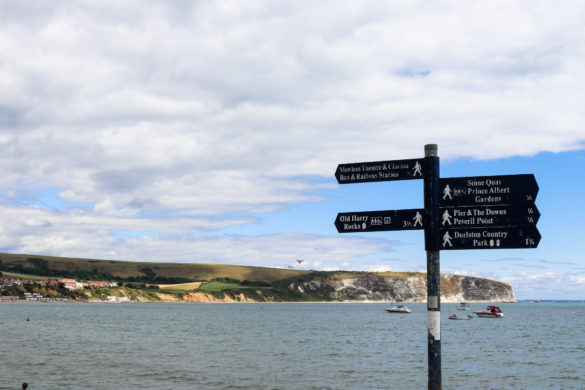 Signs at Swanage Bay with Ballard Down in the distance