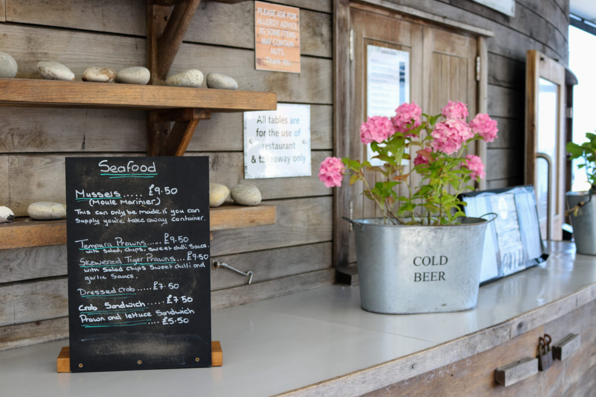 Seafood menu and flowers at Swanage restaurant