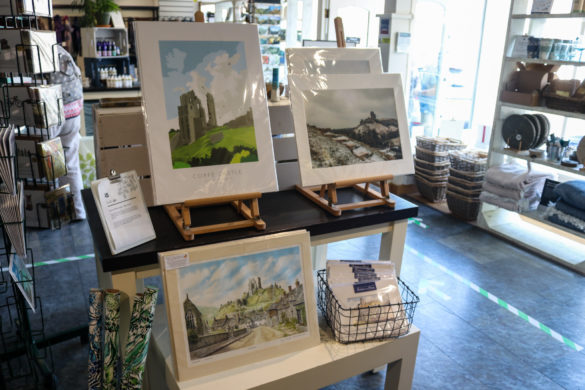 Artwork of Corfe Castle on display in the National Trust shop in the village