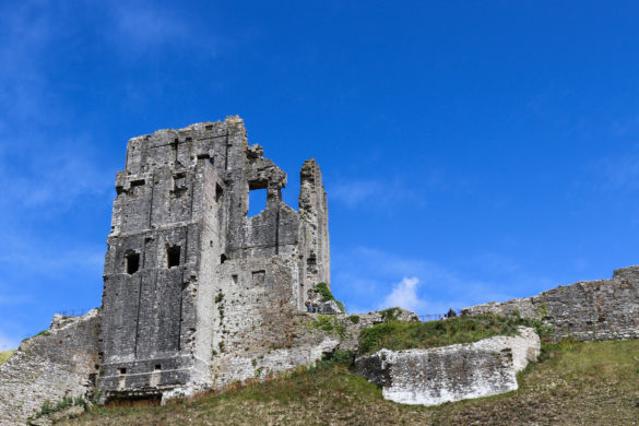 The ruined keep at Corfe Castle with blue sky behind