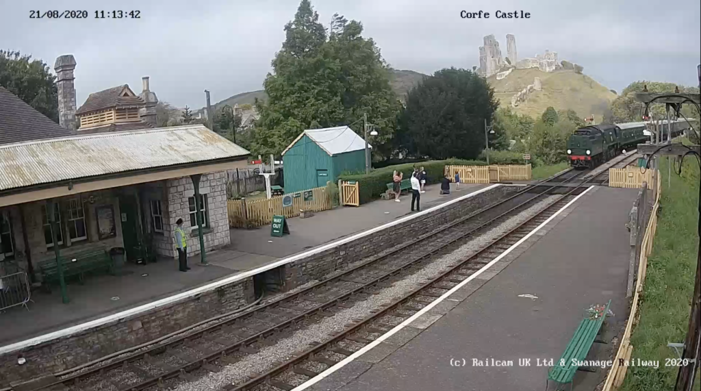 Corfe Castle station webcam with signalman waving train through