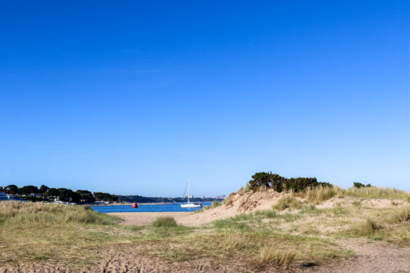 Sail boat in Poole Harbour by Shell Bay in Studland