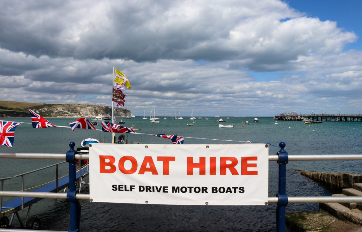 Swanage Boat Hire sign on railing