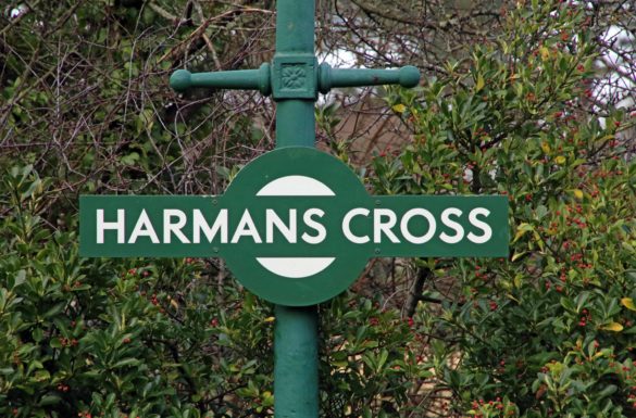 Green and white sign Harman's Cross station
