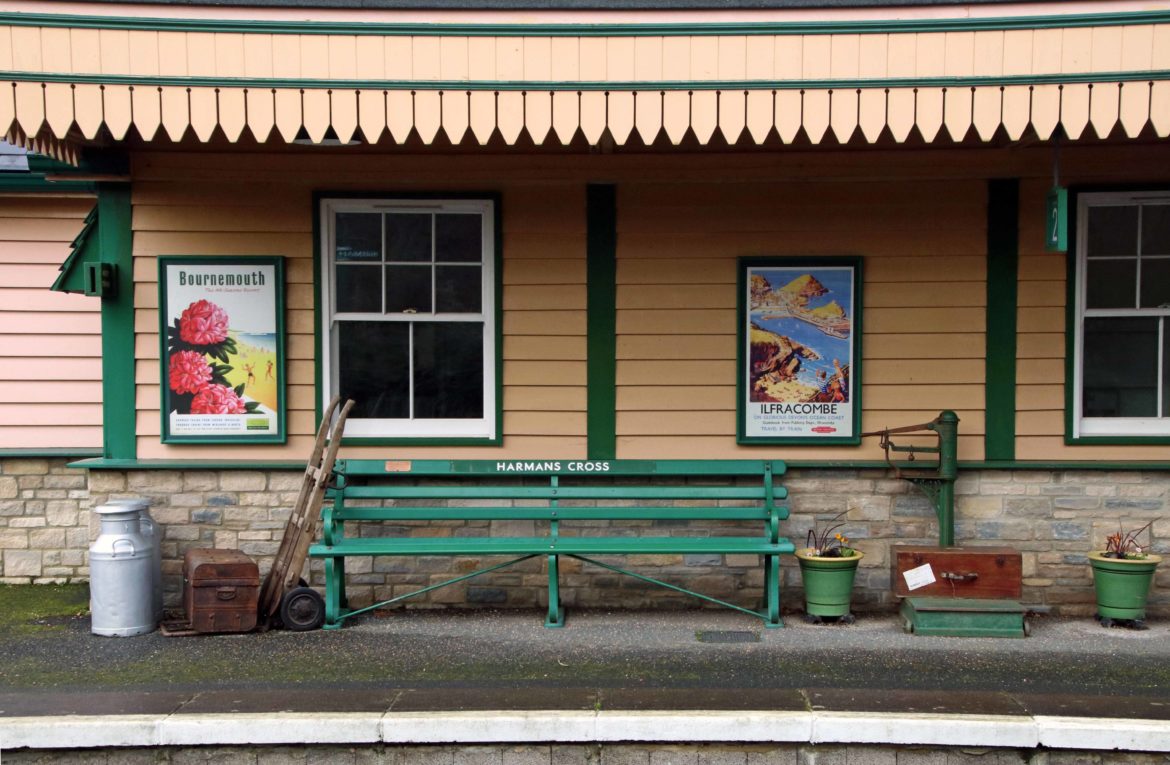Vintage posters and railway items on Harman's Cross station platform