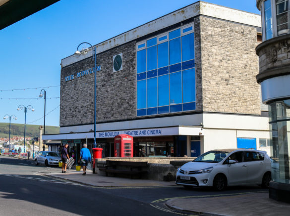 People walking past the Mowlem theatre in Swanage