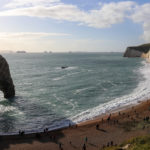 The beach at Durdle Door with people walking