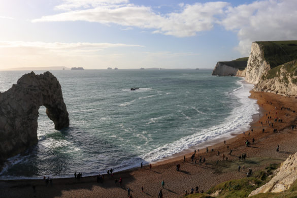 The beach at Durdle Door with people walking