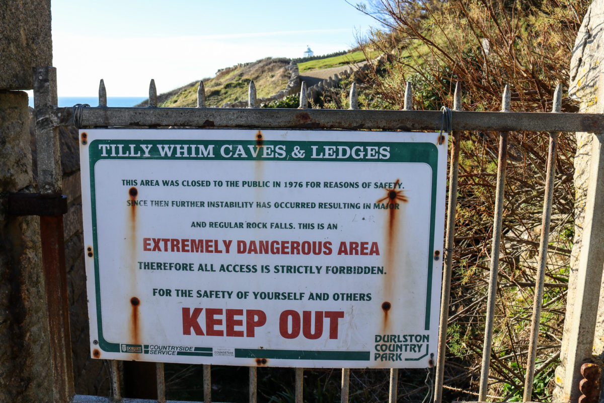 Entrance to Tilly Whim Caves with dangerous area sign at Durlston