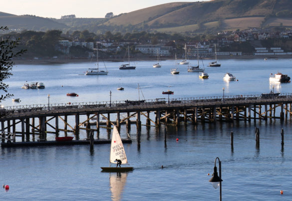 Person sailing past Swanage Pier