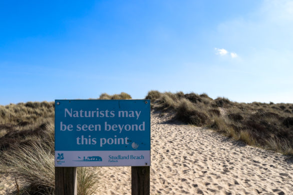 Naturists May Be Seen sign in the dunes leading to Studland Naturist Beach