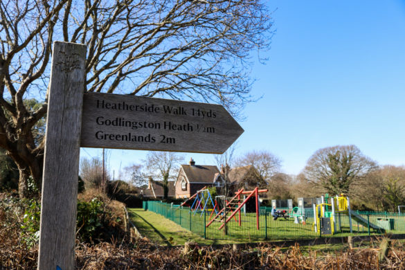 Wooden sign for Godlingston Heath outside Studland village playground