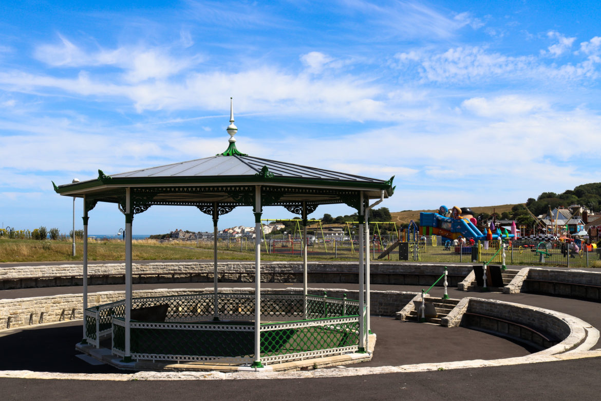 Swanage sunken bandstand with Santa Fe fun park and Chadwick Playground behind