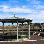 Swanage sunken bandstand with Santa Fe fun park and Chadwick Playground behind