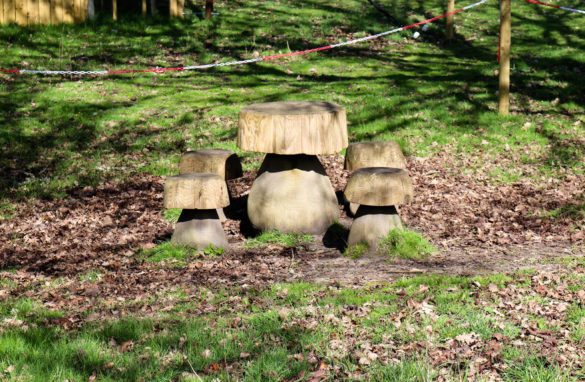 Toadstool-shaped wooden picnic bench for children at Arne