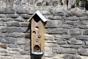 Wooden insect house on a wall near the café in Arne